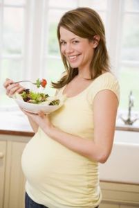 Pregnant woman laughing alone with salad. It's like someone left a box of inane tropes in the car and they all melted together.
